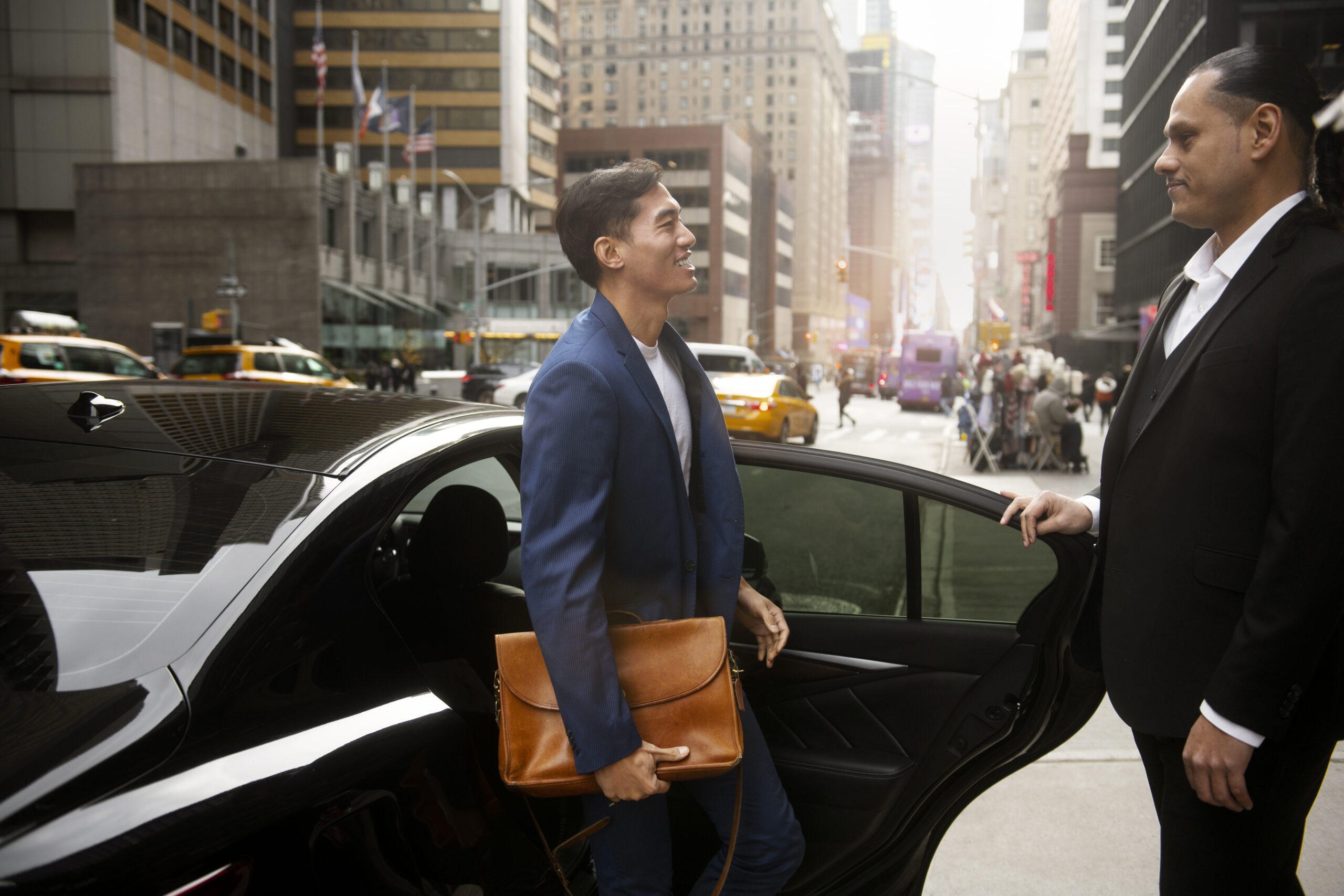Suit-clad pro with briefcase entering car in city. Promotes Delhi corporate car rental for airport transfers.