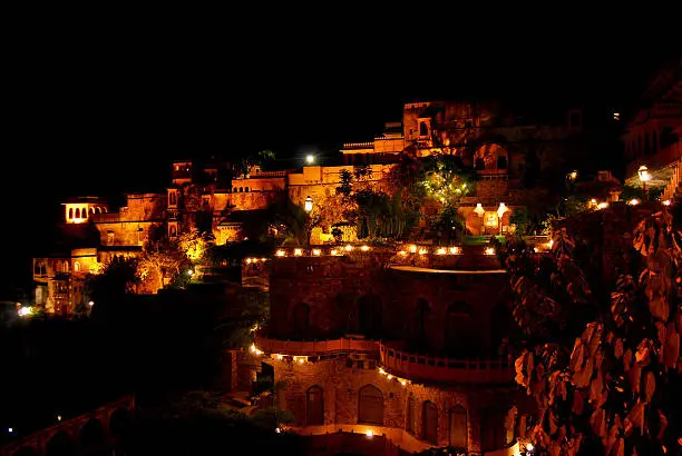 Family road trip to Neemrana Fort, showcasing its stunning night view with warm lights illuminating the historic architecture