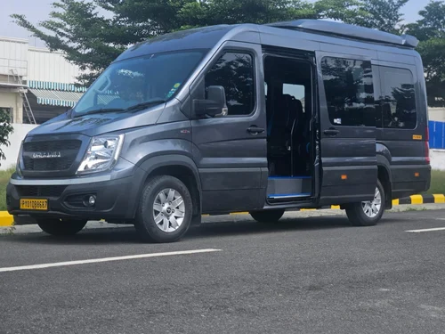 Force Urbania luxury van with open sliding door, perfect for group travel and rentals in Delhi